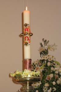 A lit traditional Paschal candle